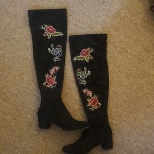 Knee high embroidered black boots.